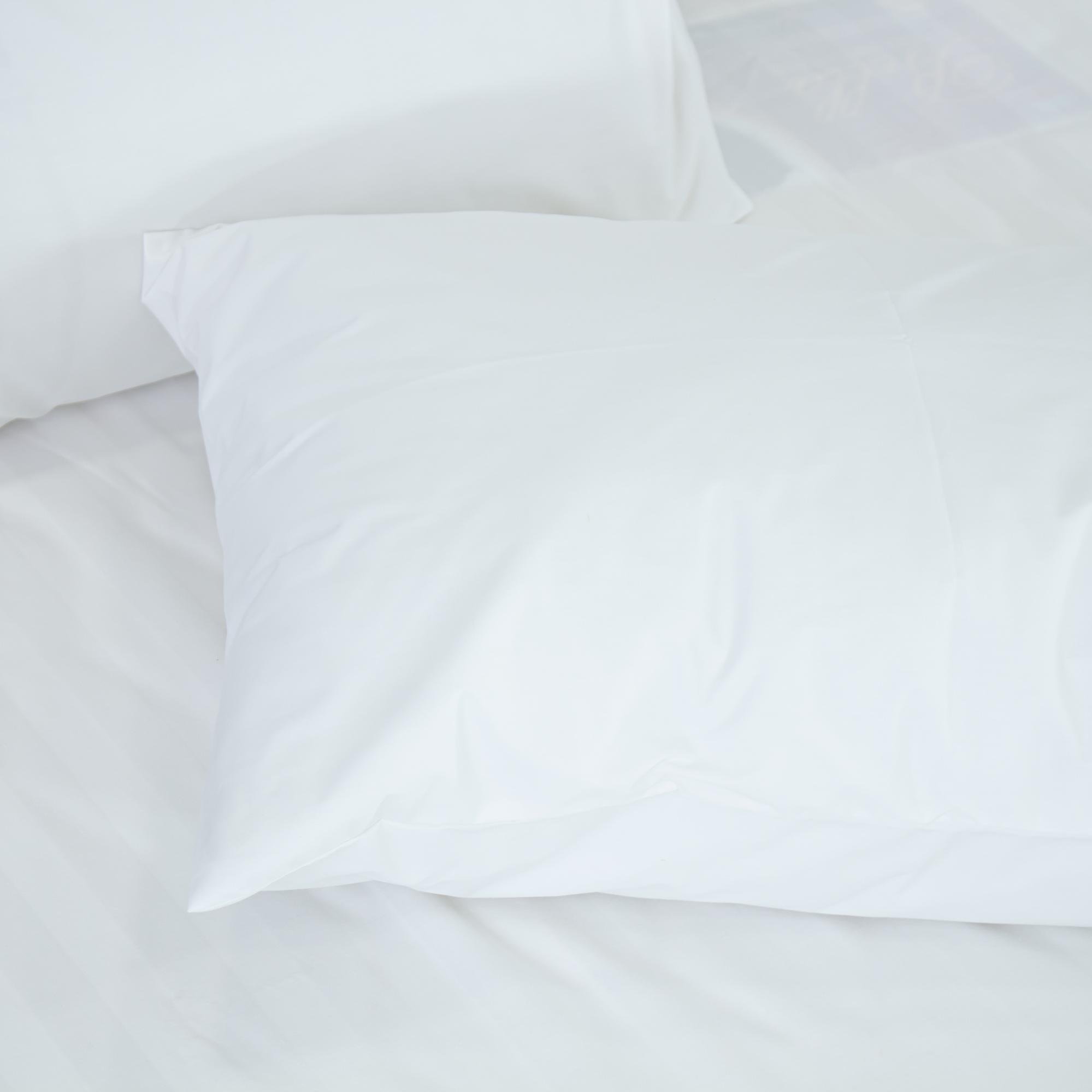 Cách Chọn Gối Khách Sạn Theo Hạng Sao: Ruột Gối, Vỏ Gối Và Số Lượng Mỗi Giường 7 Gối nằm khách sạn màu trắng trên giường